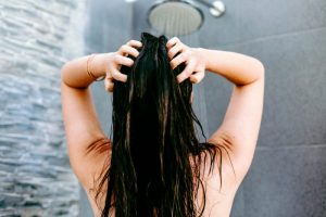 picture of a woman with hair loss losing hair in the shower