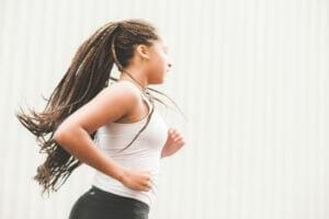 picture of a woman running to get exercise to help her body remove toxins that cause infertility because of the negative impact of toxins on fertility