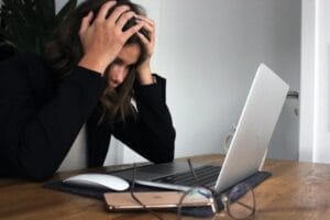 Overcoming Stress: A Powerful Weapon for Better Fertility picture of a woman who is under a lot of stress and dealing with infertility wondering how stress management and mindfulness techniques can improve fertility
