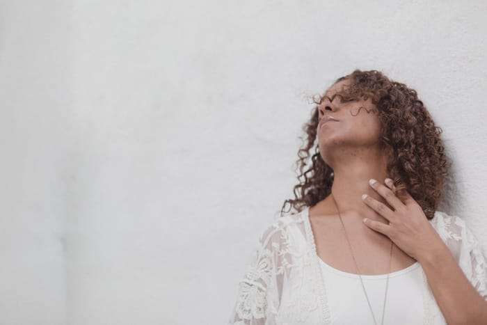 8 Natural Remedies for Menopause Relief picture of a woman feeling hot because she is having a hot flash and mood swings because of perimenopause and menopause looking for menopause relief with natural remedies