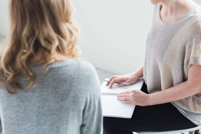 The Key to Natural Hormone Balance and Fertility picture of a fertility naturopath with a woman dealing with unexplained infertility helping to understand hormone imbalances and achieve natural hormone balance