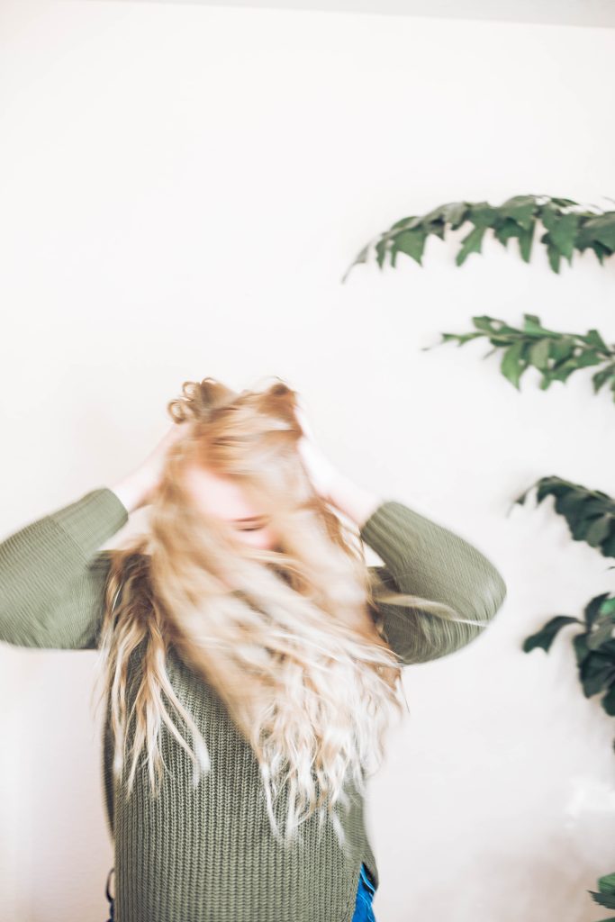 picture of a woman holding her head wondering about natural remedies for stress and balancing her cortisol with herbs