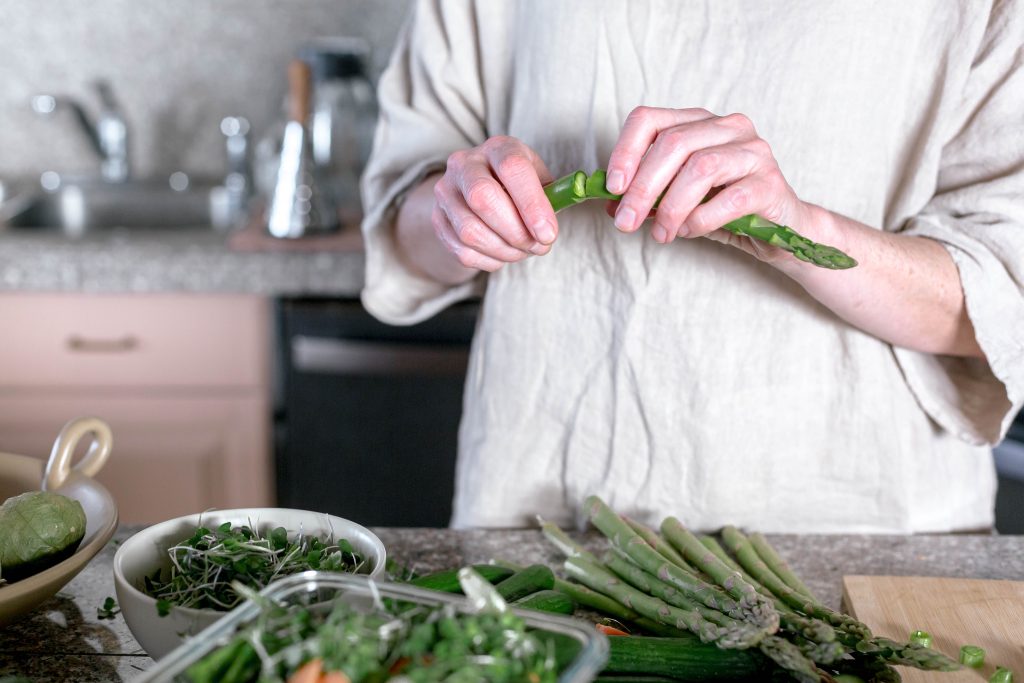 Individualized Medicine and PCOS: What We Can Say picture of a woman making a salad for personalized medicine and PCOS diet