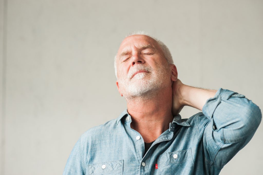 picture of a man holding his neck wondering about natural remedies for stress and balancing his cortisol with herbs