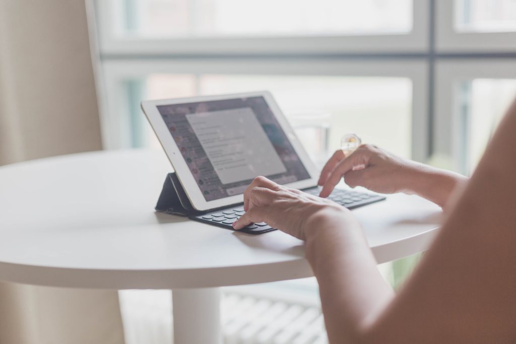 Your Cycle Speaks. Are You Listening? Hormone Health Checklist picture of a woman at a computer downloading a hormone health checklist