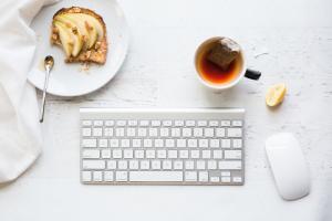 picture of herbal tea and a keyboard of someone who is taking health advice from AI