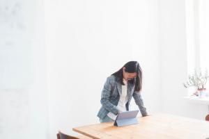 Wondering If A Naturopath is Covered by Insurance or OHIP in Ontario? picture of a woman checking on her tablet to see if a naturopath is covered by insurance