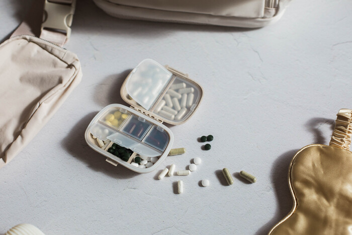 Post-Birth Control Syndrome: Separating Evidence From Speculation picture of a pill box with pills on a table from a woman with post-birth control syndrome